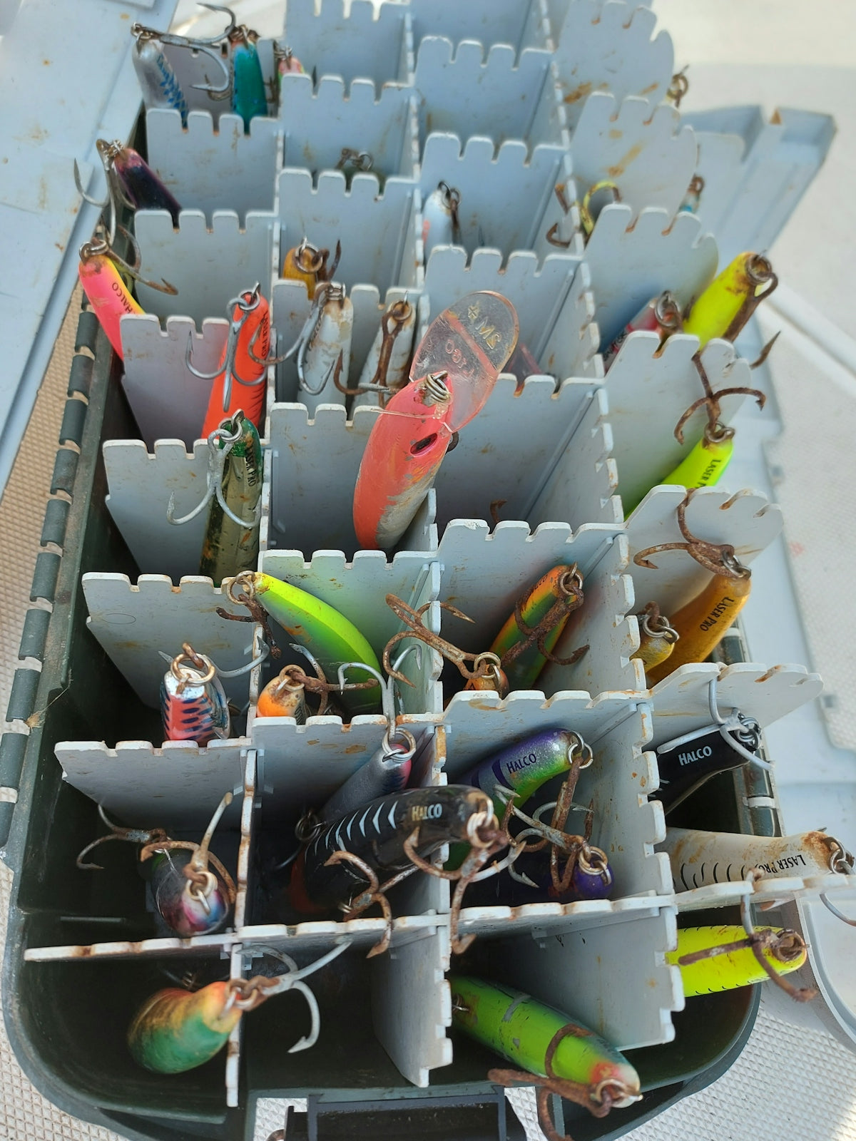 a bunch of fishing lures are in a bin